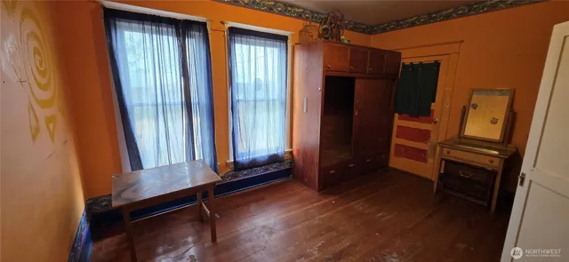 a area with a window and wooden floor