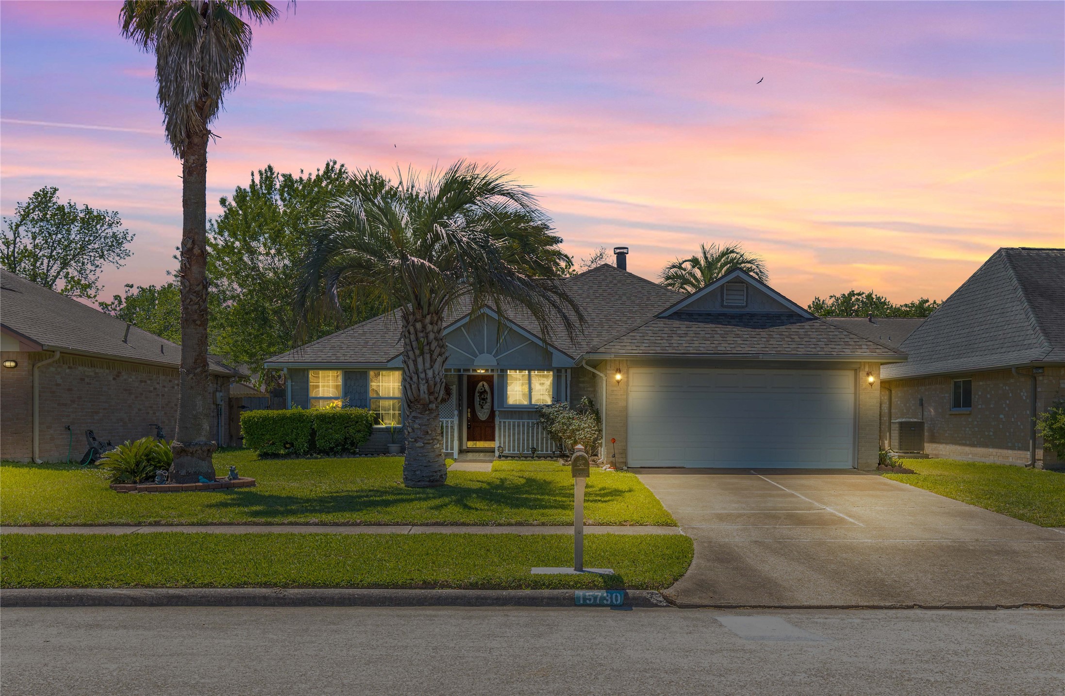 a front view of a house with a garden and a yard