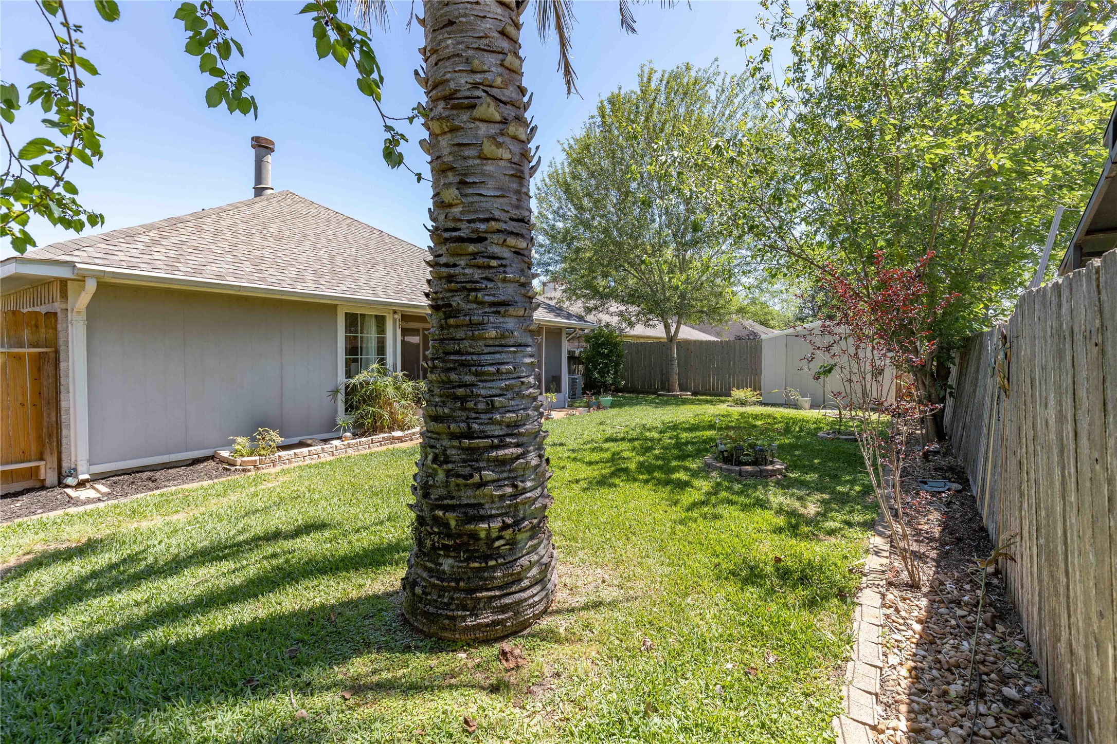 15730 Castorglen Drive Houston, TX 77598 - Photo 11 of 38 a backyard of a house with plants and large tree
