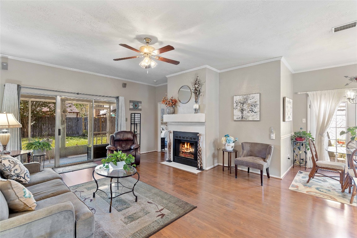 15730 Castorglen Drive Houston, TX 77598 - Photo 17 of 38 a living room with furniture a fireplace and a large window