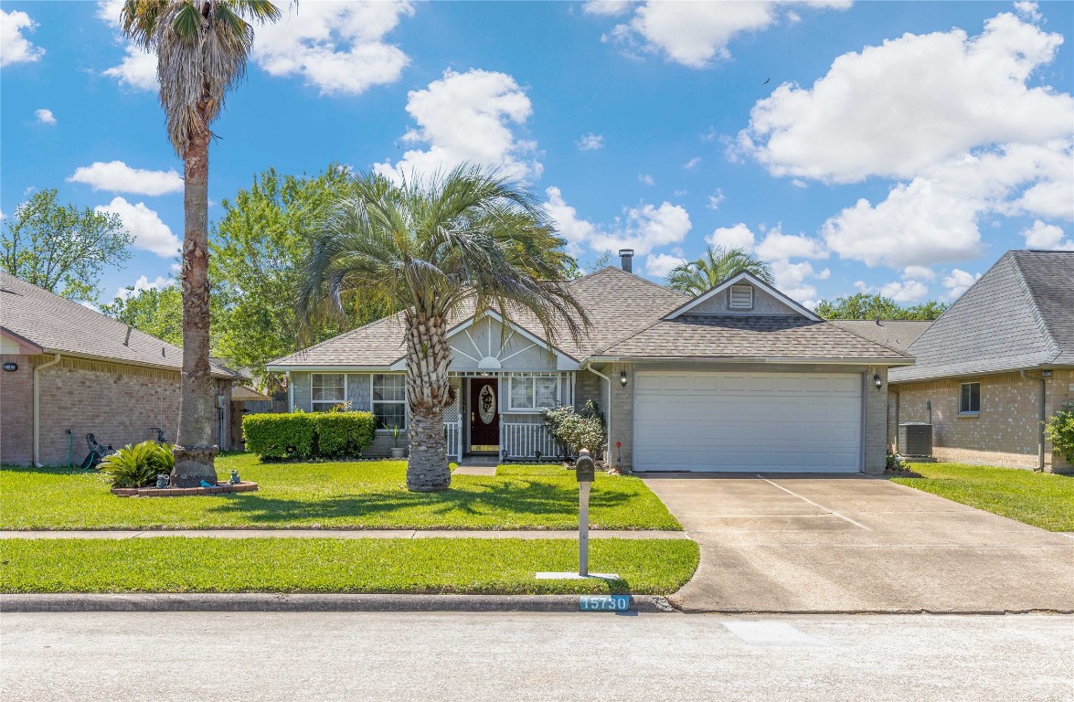 15730 Castorglen Drive Houston, TX 77598 - Photo 2 of 38 a front view of a house with a garden and a yard