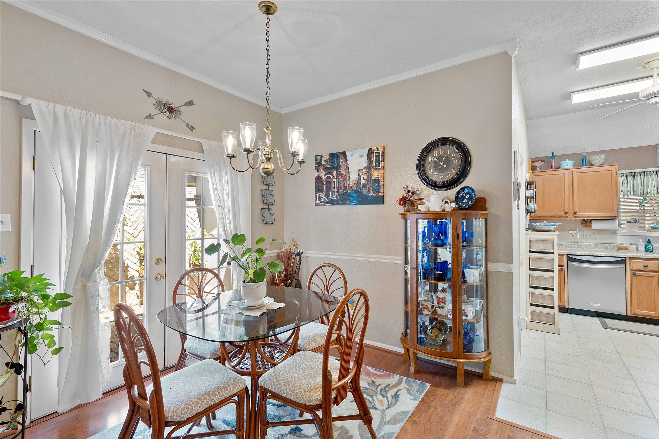 15730 Castorglen Drive Houston, TX 77598 - Photo 21 of 38 a view of a dining room and kitchen with furniture wooden floor and a clock