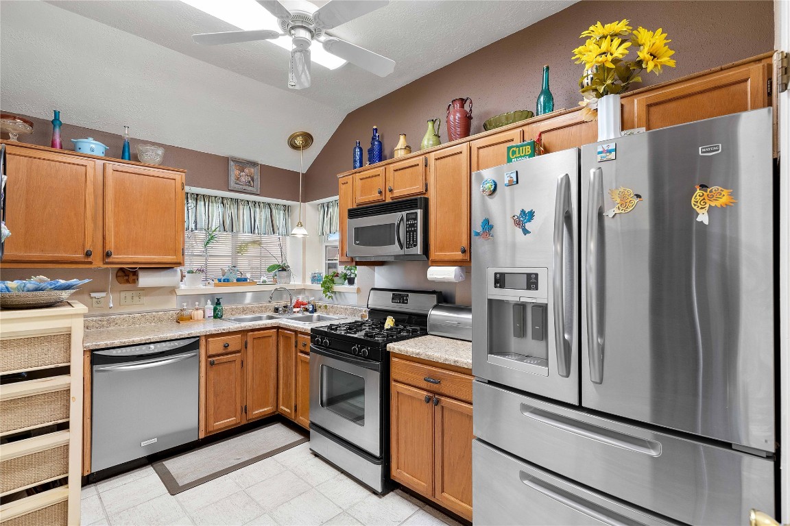15730 Castorglen Drive Houston, TX 77598 - Photo 23 of 38 a kitchen with stainless steel appliances a stove a refrigerator and a sink