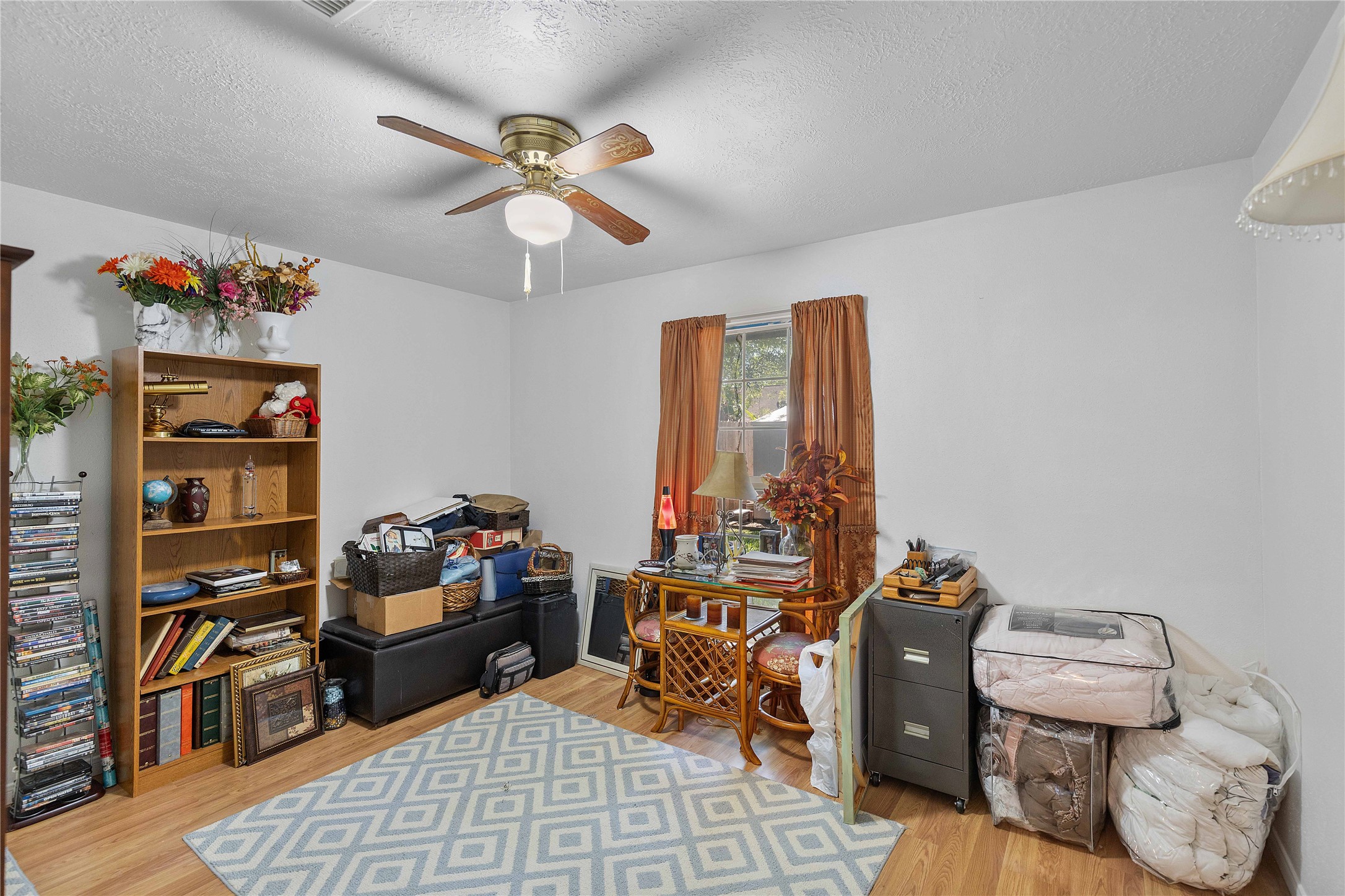 15730 Castorglen Drive Houston, TX 77598 - Photo 33 of 38 a room with furniture a rug and a chandelier