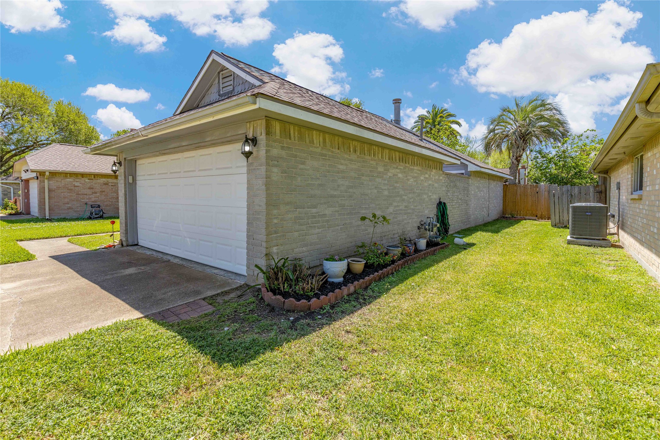 15730 Castorglen Drive Houston, TX 77598 - Photo 6 of 38 a yellow house with flower garden in front of it