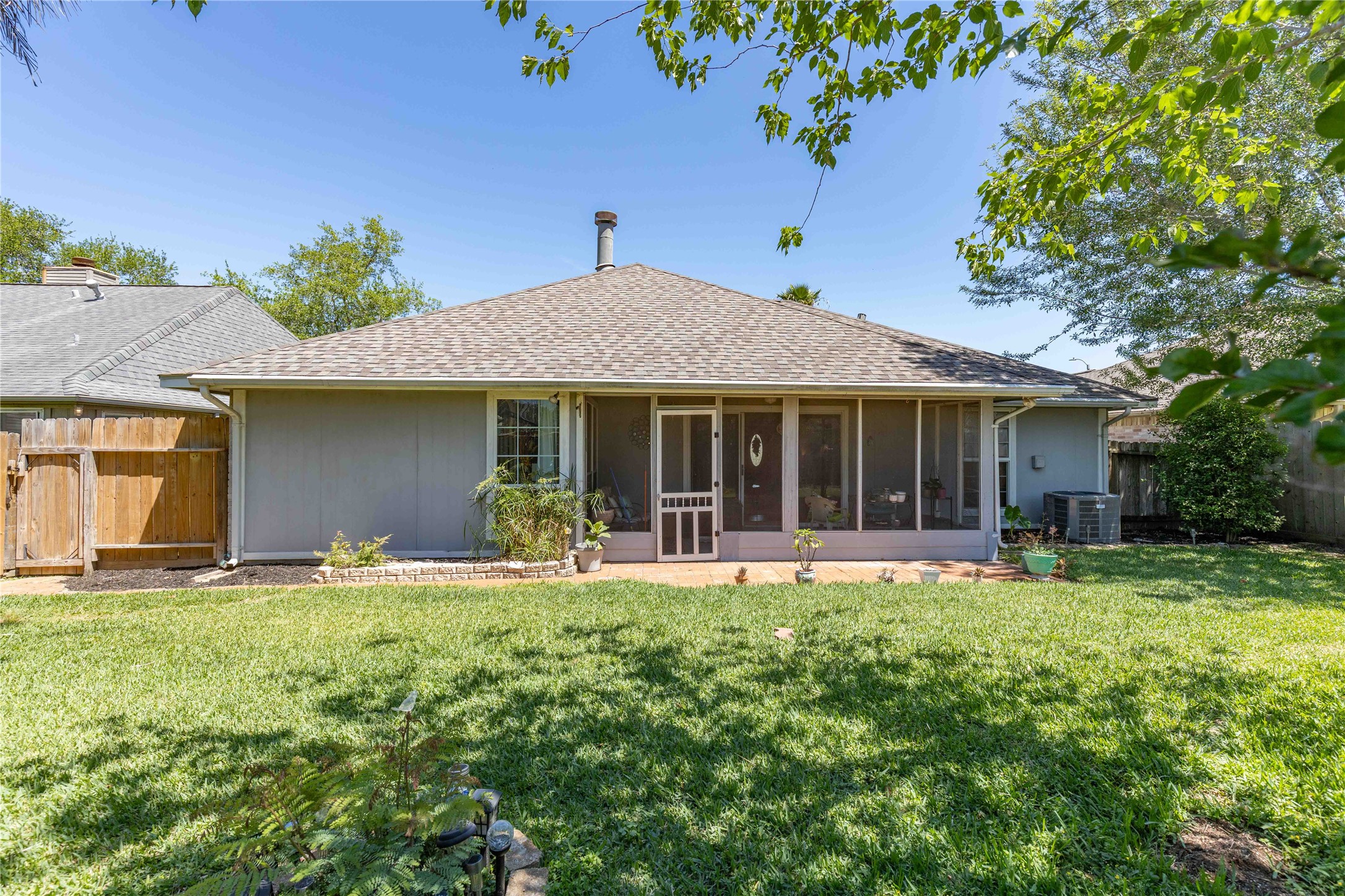 15730 Castorglen Drive Houston, TX 77598 - Photo 7 of 38 a front view of a house with a garden and porch
