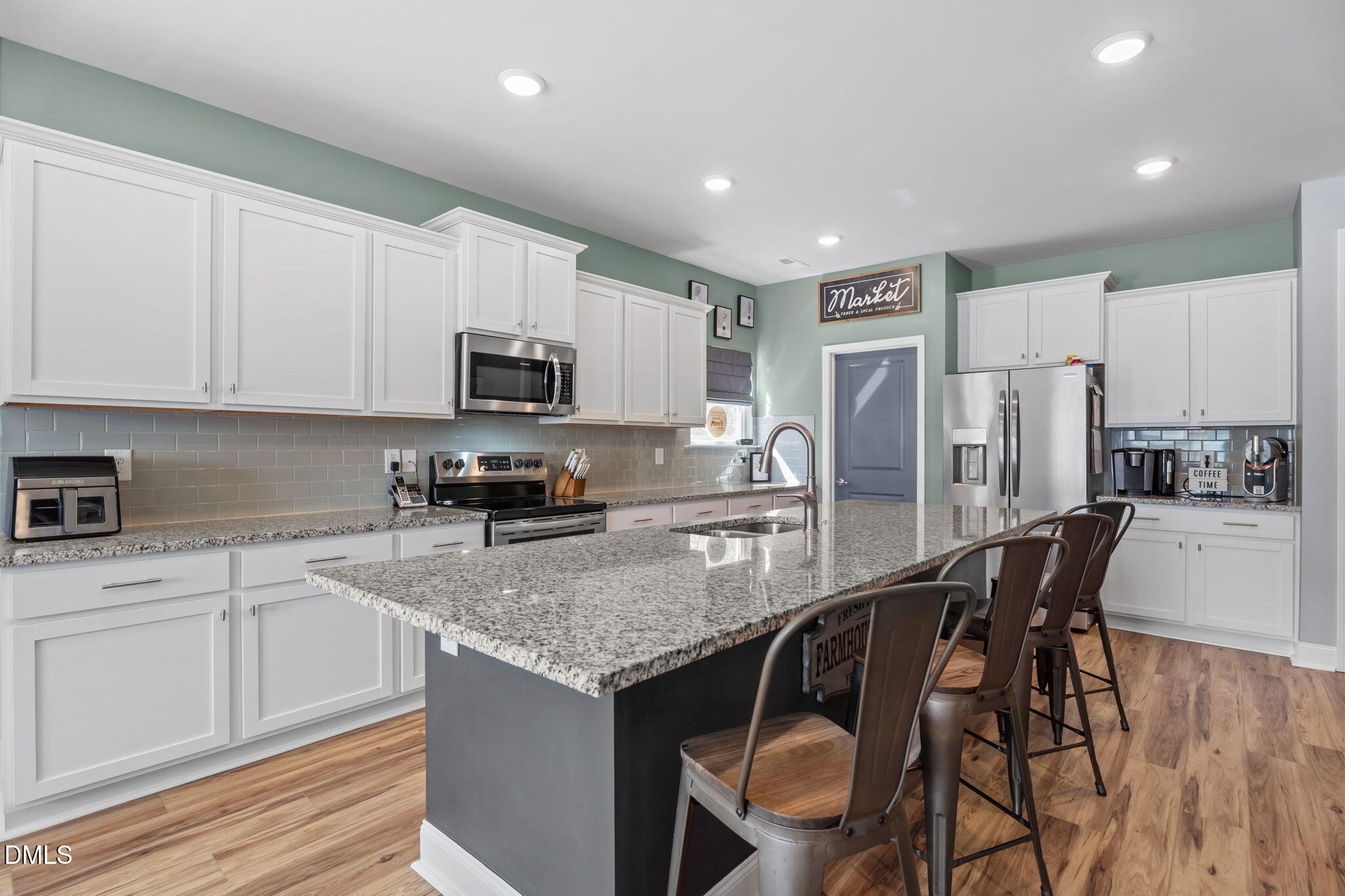 9405 Whitley Road Bailey, NC 27807 - Photo 15 of 51 a kitchen with stainless steel appliances granite countertop a stove a sink a microwave a refrigerator white cabinets and wooden floor