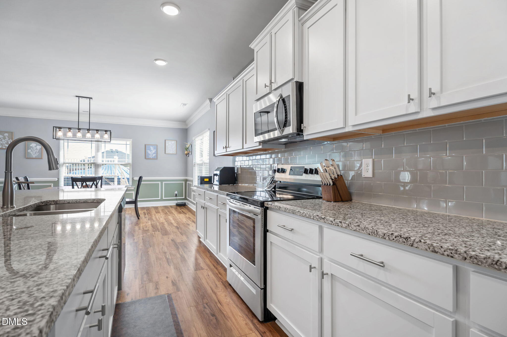 9405 Whitley Road Bailey, NC 27807 - Photo 16 of 51 a kitchen with stainless steel appliances granite countertop a stove a sink dishwasher and cabinets with wooden floor