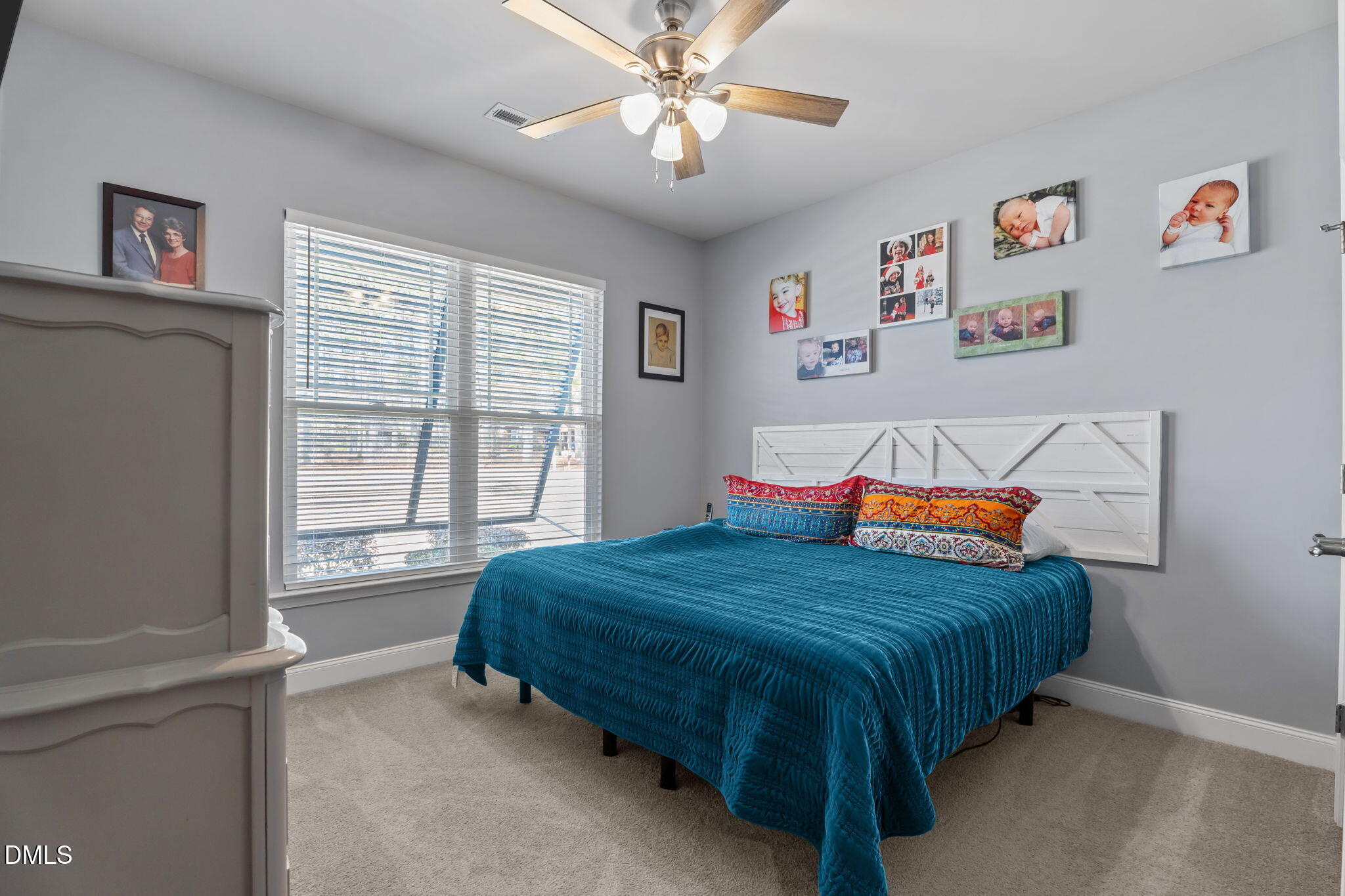 9405 Whitley Road Bailey, NC 27807 - Photo 32 of 51 a bedroom with a bed and a chandelier