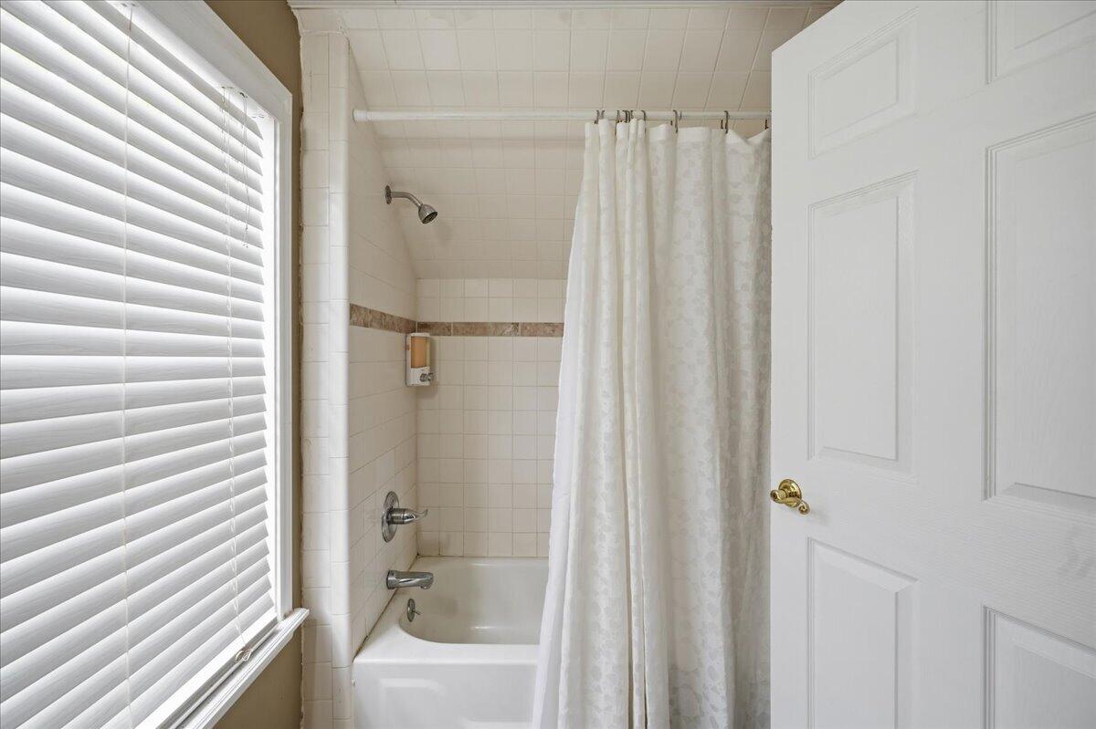 2702 20th Street Lubbock, TX 79410 - Photo 27 of 34 a bathroom with a shower and a tub