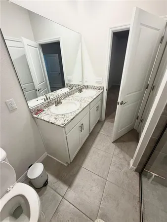 a bathroom with a sink a toilet and mirror