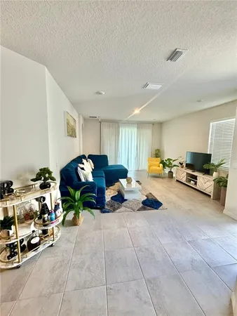 a living room with furniture a parked car and a window