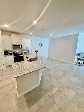 a kitchen with kitchen island cabinets and refrigerator