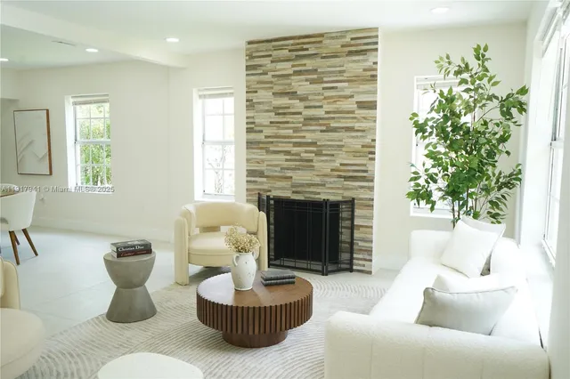 a living room with furniture and a fireplace