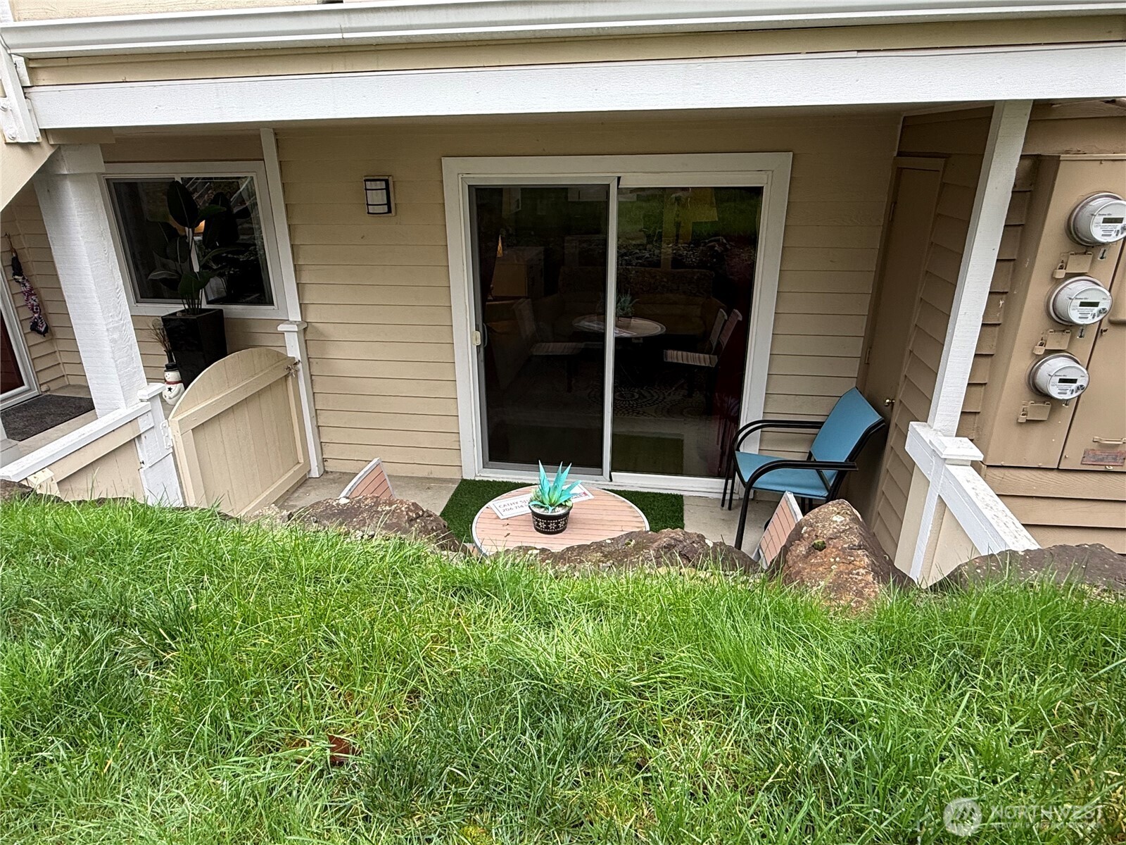 21301 52nd Avenue West, Unit B112 Mountlake Terrace, WA 98043 - Photo 15 of 17 a front view of a house with a yard glass top table and chairs