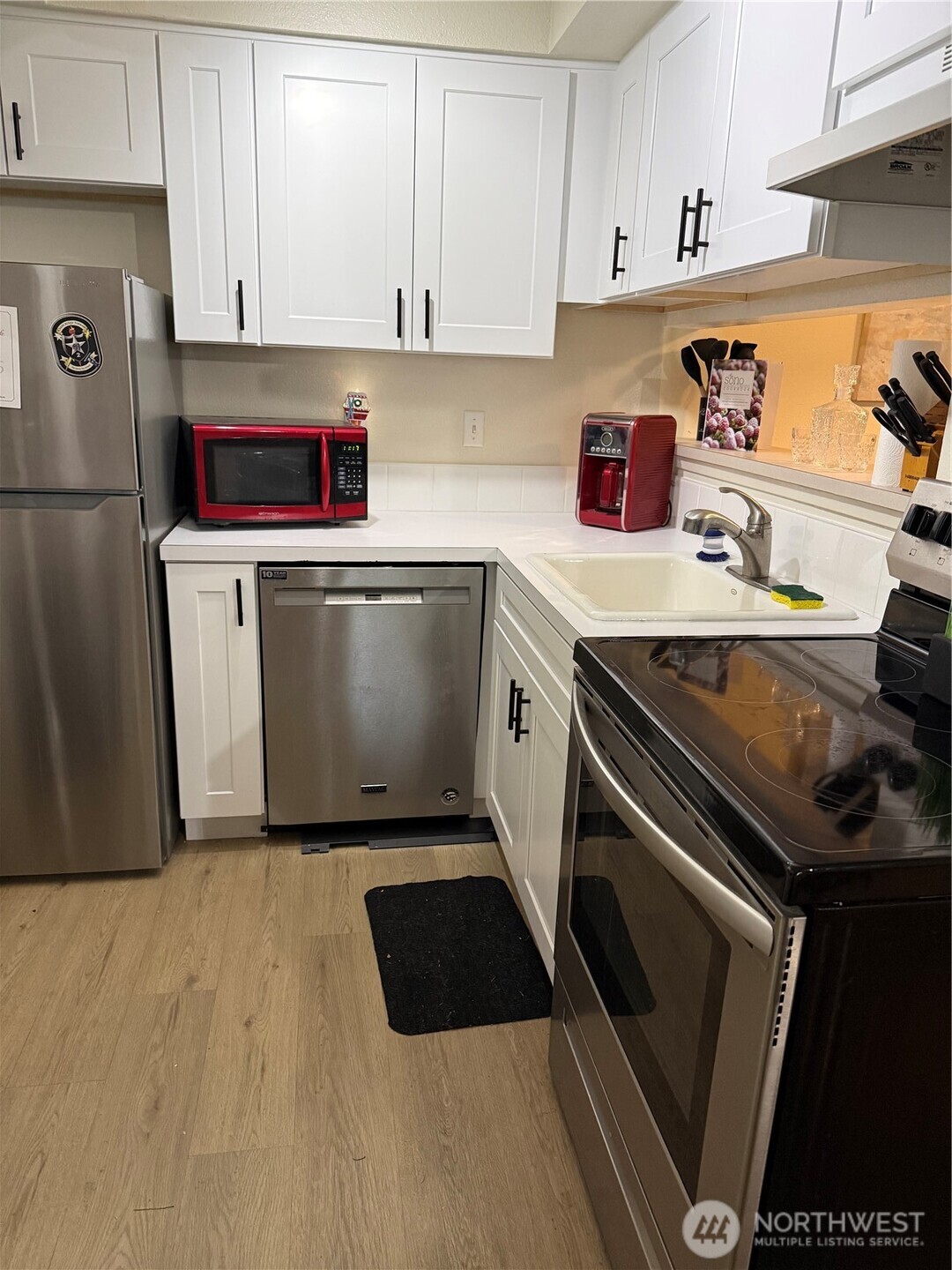 21301 52nd Avenue West, Unit B112 Mountlake Terrace, WA 98043 - Photo 5 of 17 a kitchen with a refrigerator sink and cabinets