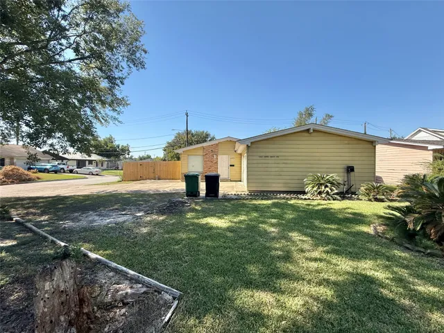 a view of a backyard with plants and a tree