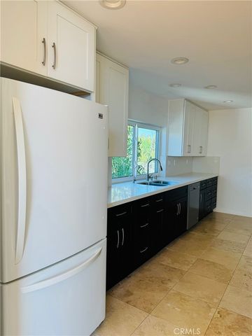 a stove top oven sitting inside of a kitchen