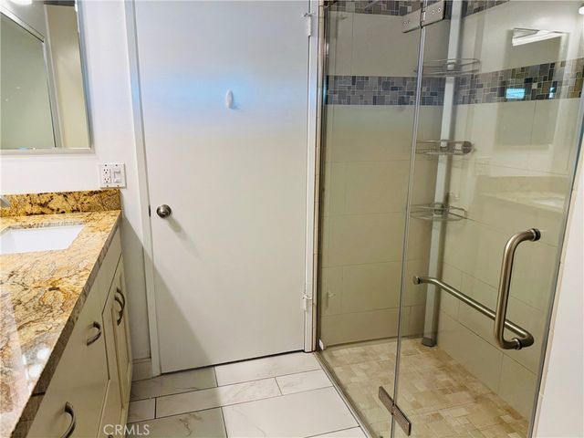 a view of a floor to ceiling window and a tree