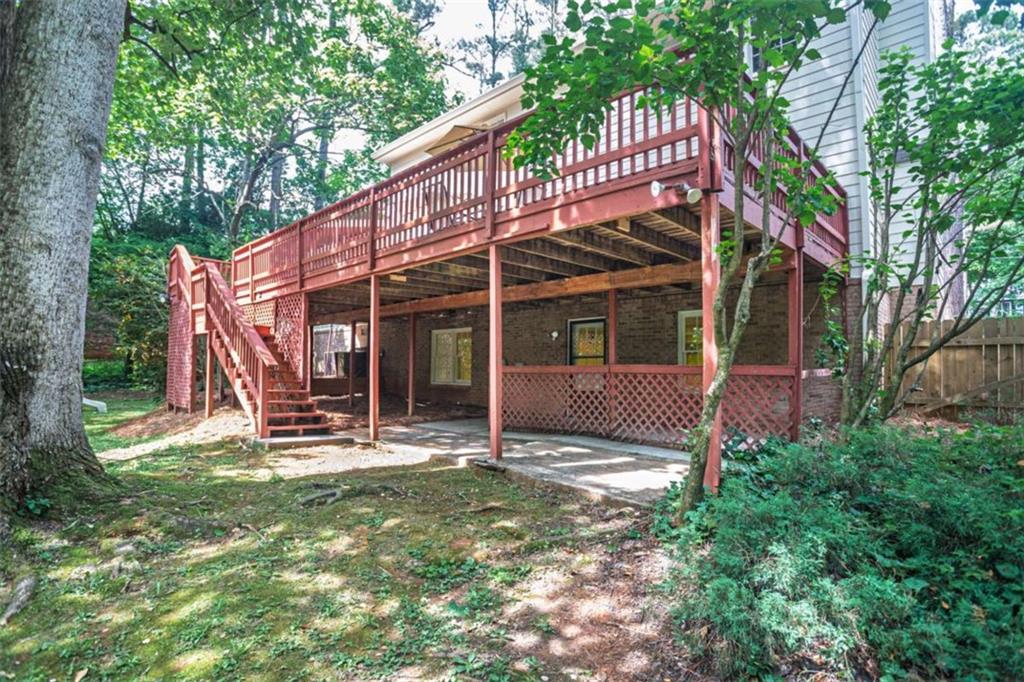 3838 Hunting Ridge Drive Southwest Lilburn, GA 30047 - Photo 53 of 56 a view of a house with backyard porch and sitting area