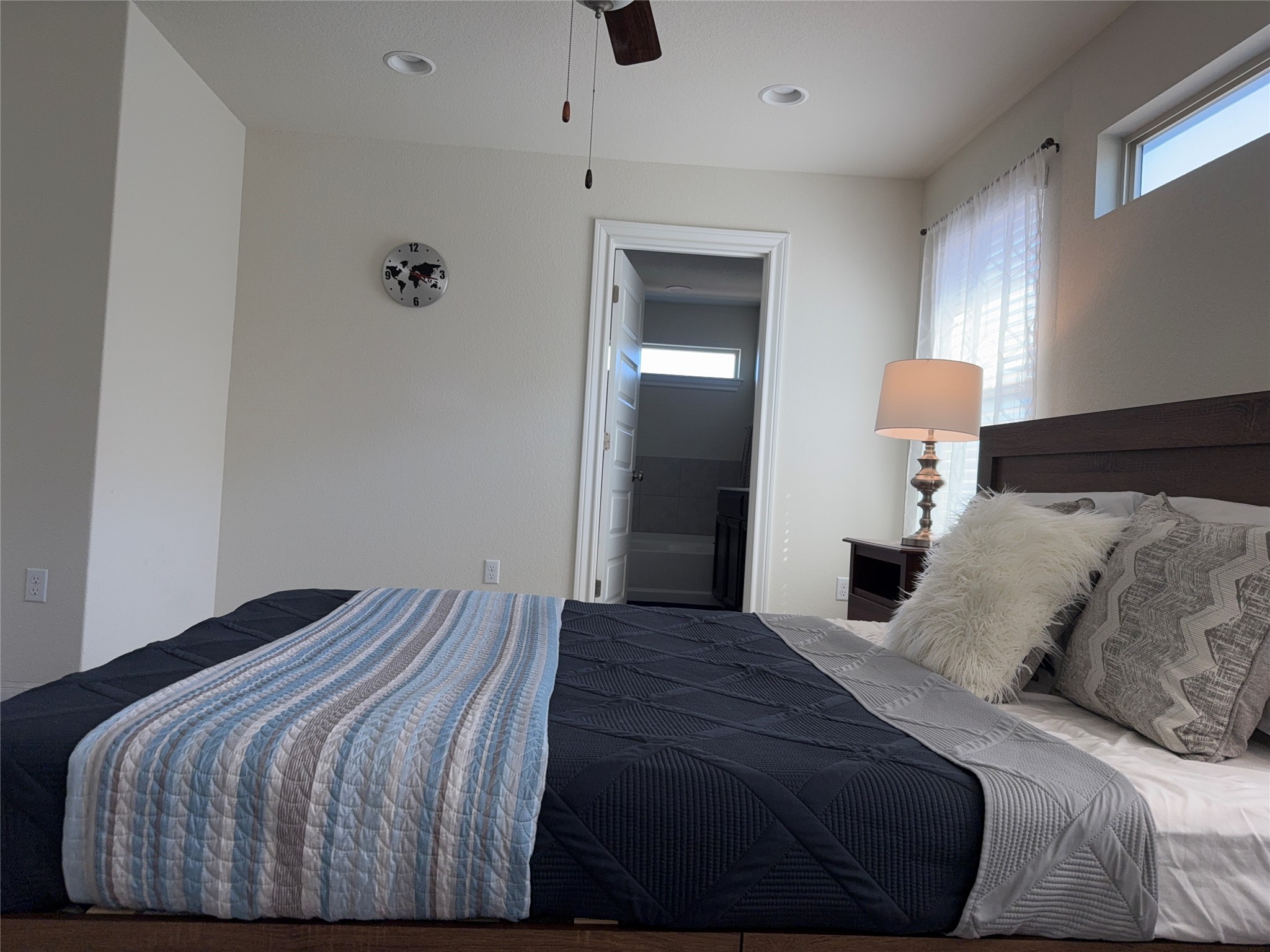 16109 Nightshade Street Austin, TX 78728 - Photo 11 of 24 a bedroom with a bed and a lamp