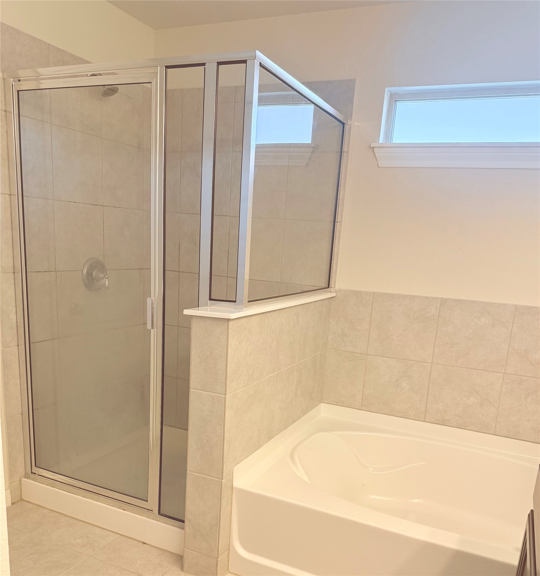 16109 Nightshade Street Austin, TX 78728 - Photo 18 of 24 a bathroom with a bathtub and a shower
