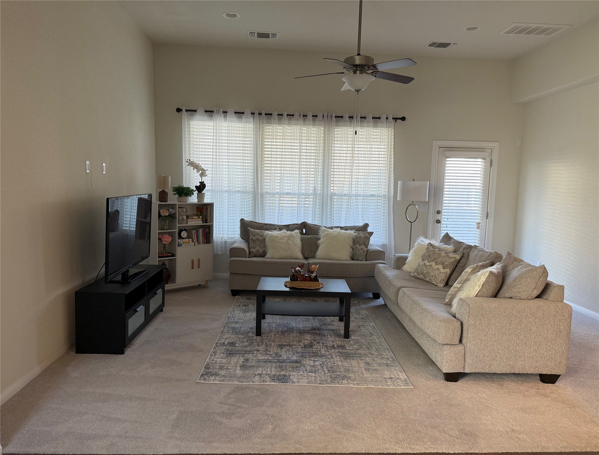 16109 Nightshade Street Austin, TX 78728 - Photo 5 of 24 a living room with furniture a large window and a flat screen tv