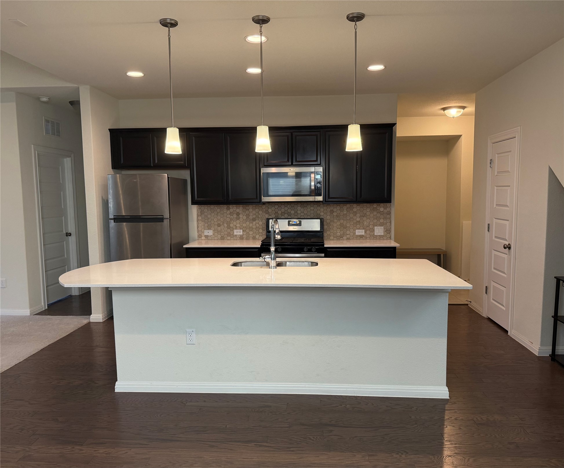 16109 Nightshade Street Austin, TX 78728 - Photo 9 of 24 a kitchen with kitchen island a sink stainless steel appliances and cabinets