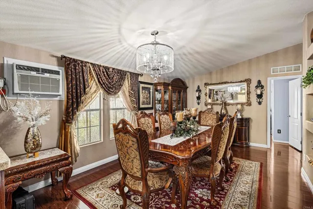 a view of a dining room with furniture wooden floor and chandelier