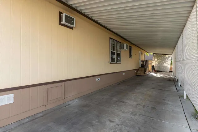 a view of a pathway of a house with wooden fence