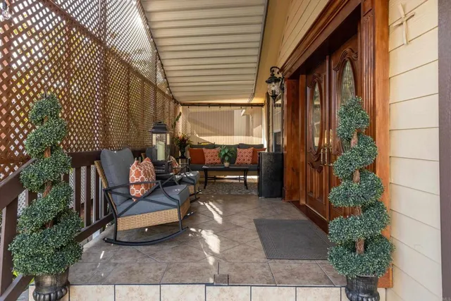 a building outdoor space with patio furniture and potted plants
