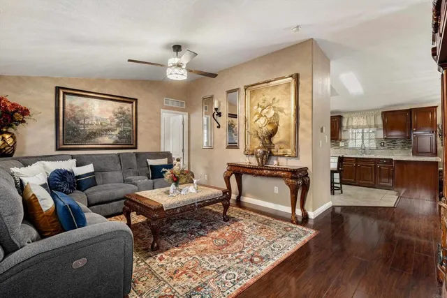 a living room with furniture and wooden floor