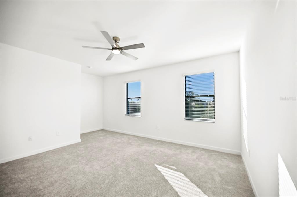 14812 Lyla Terrace Lakewood Ranch, FL 34211 - Photo 19 of 65 an empty room with windows and fan