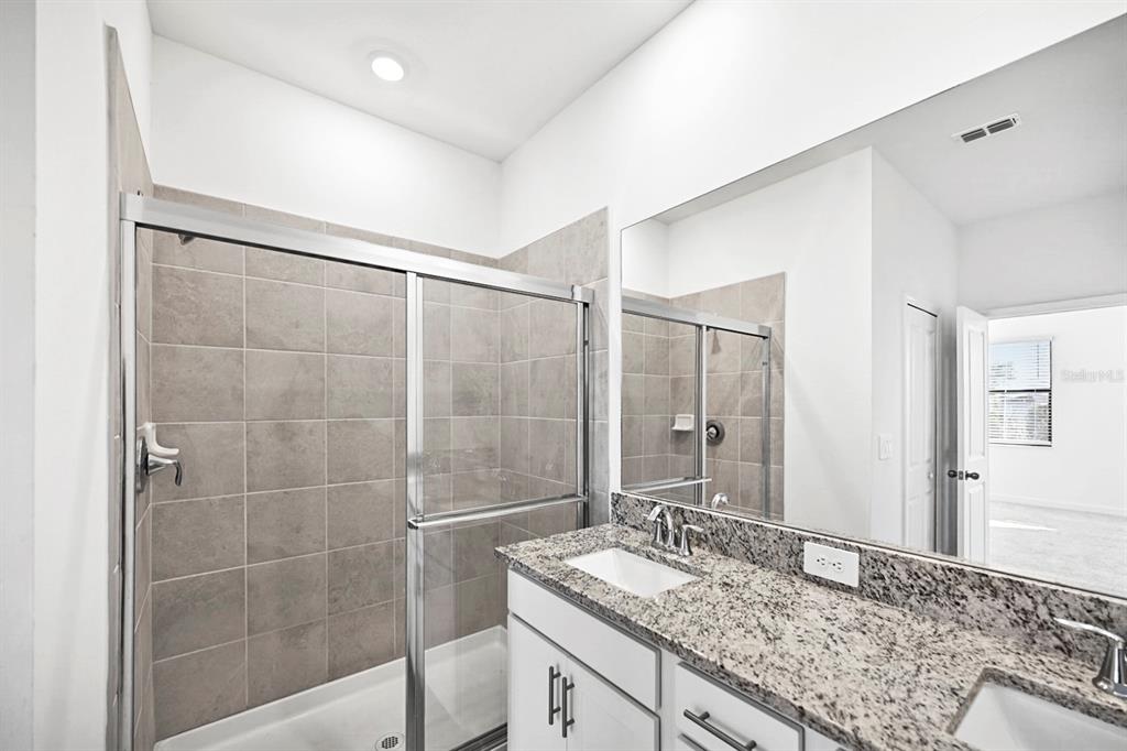14812 Lyla Terrace Lakewood Ranch, FL 34211 - Photo 21 of 65 a bathroom with a granite countertop sink and a mirror