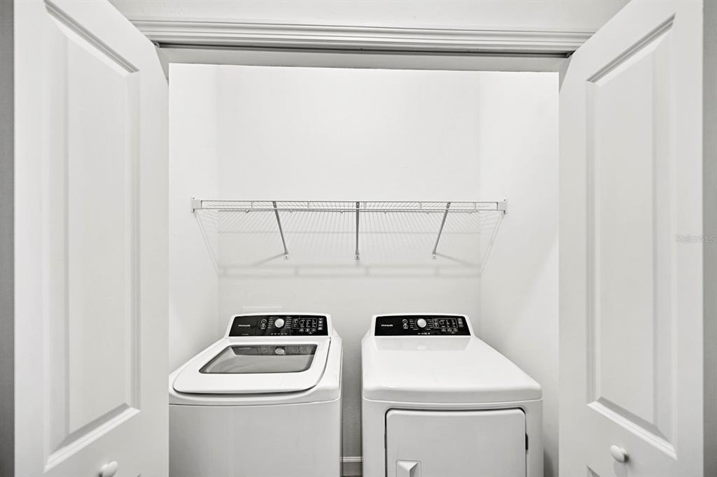 14812 Lyla Terrace Lakewood Ranch, FL 34211 - Photo 23 of 65 a view of storage and utility room with washer and dryer