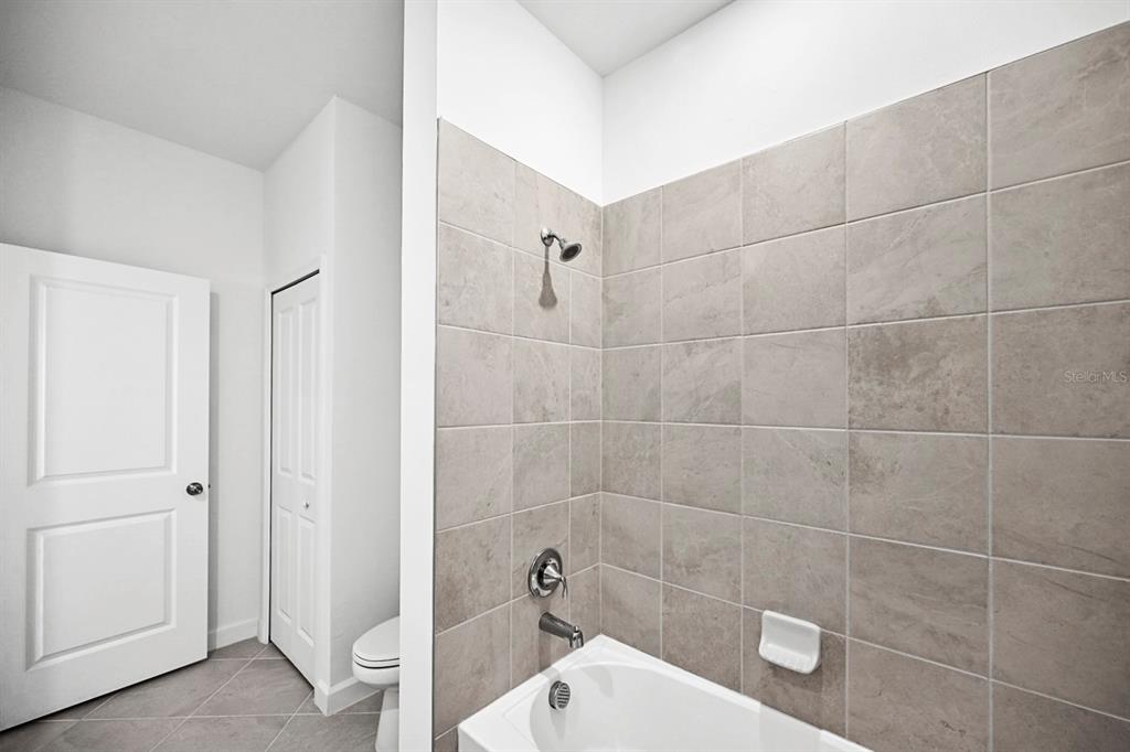 14812 Lyla Terrace Lakewood Ranch, FL 34211 - Photo 25 of 65 a bathroom with a toilet and a shower