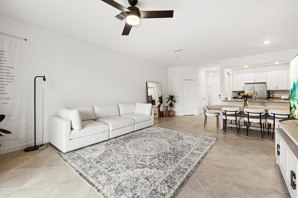 14812 Lyla Terrace Lakewood Ranch, FL 34211 - Photo 8 of 65 a living room with furniture and a rug
