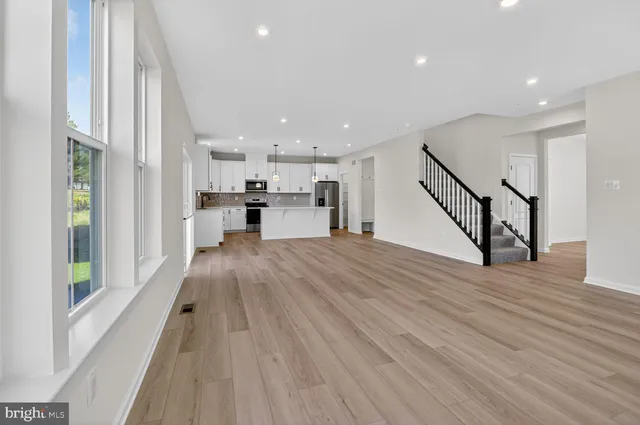 a view of a kitchen with wooden floor and electronic appliances