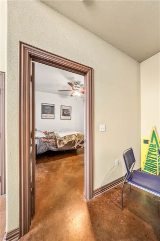 a view of a room that has a bed and a chair in it