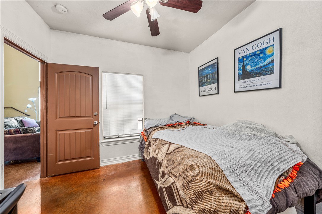 2410 2nd Street South Waco, TX 76706 - Photo 19 of 36 a bedroom with a bed and a chandelier