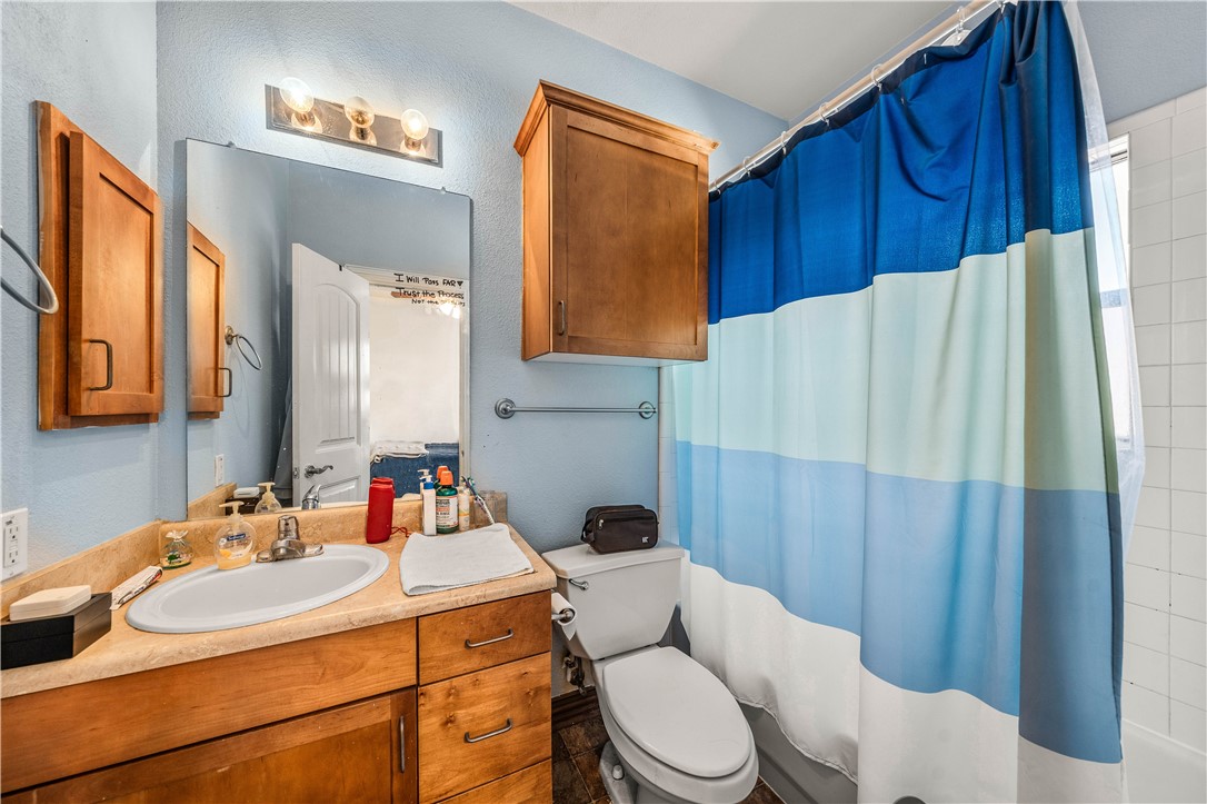 2410 2nd Street South Waco, TX 76706 - Photo 26 of 36 a bathroom with a sink vanity mirror and toilet