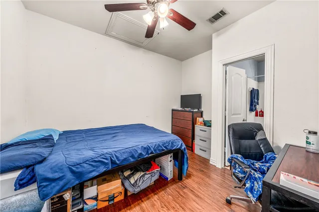 a bedroom with a bed and a chair