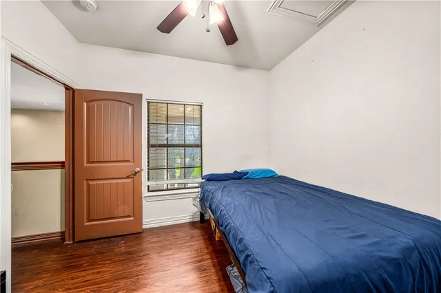 a bedroom with a bed and a window