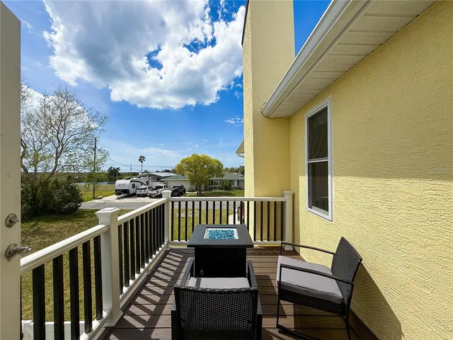 a view of a livingroom and a dining room with furniture wooden floor and chandelier