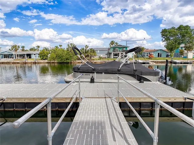 a bedroom with a bed a chandelier and a window