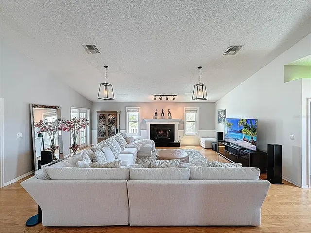 a living room with furniture and wooden floor