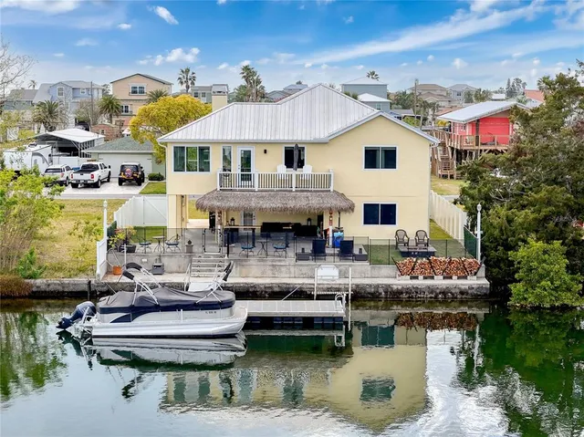a view of a house with swimming pool and furniture