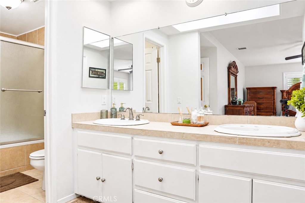 2164 North Date Avenue Rialto, CA 92377 - Photo 9 of 20 Primary bathroom with dual sinks, updated cabinetry and tiled shower.