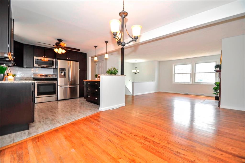1313 Star Ridge Drive Pittsburgh, PA 15241 - Photo 11 of 36 a open kitchen with refrigerator stove and wooden floor