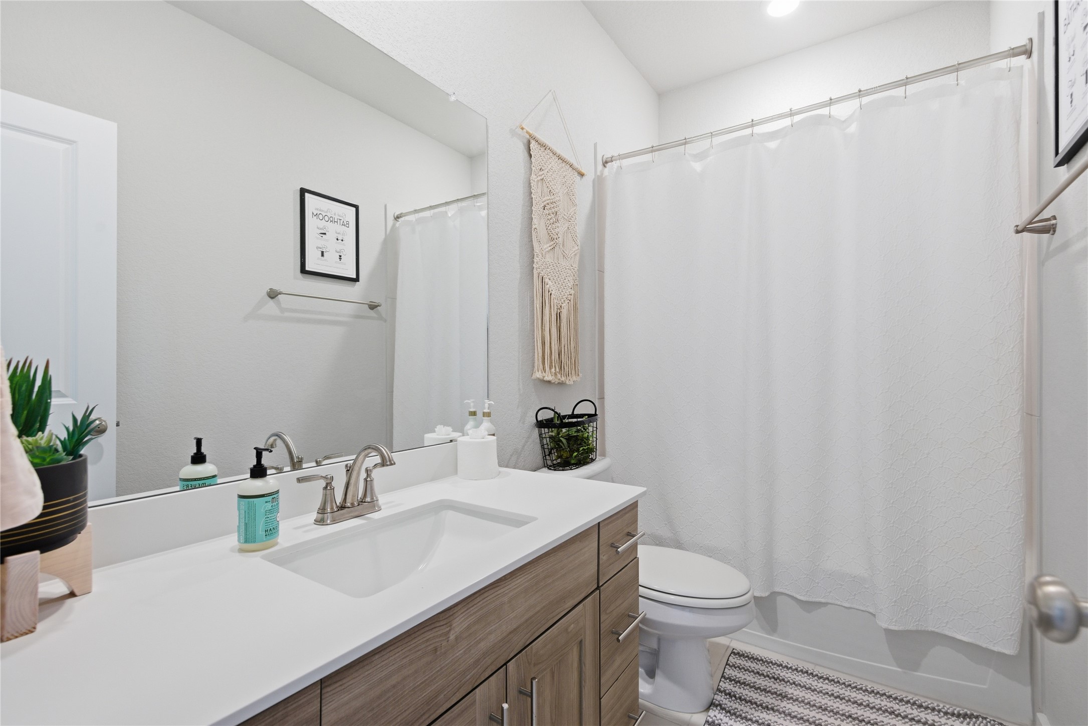 1008 Summer Glen Georgetown, TX 78628 - Photo 27 of 34 a bathroom with a sink a toilet and shower curtain